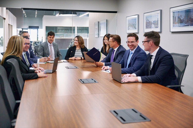 A team meeting around a conference table, photographed on location by ATX Headshots