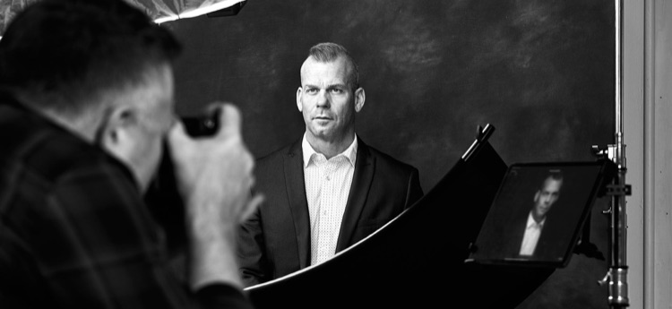 Ryan Dunbar photographing a client at the ATX Headshots studio in Cedar Park