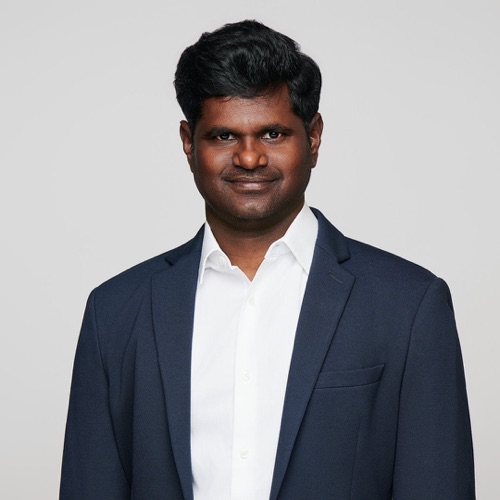 Headshot of a man in a navy blazer and white open-collar shirt, ATX Headshots