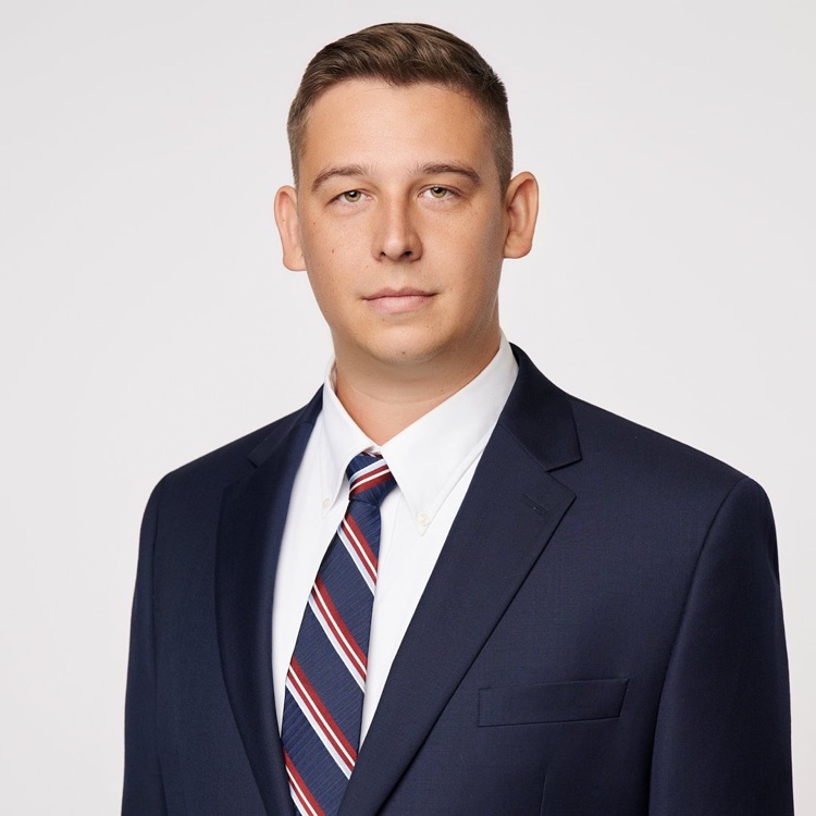 Headshot of a man in a navy suit and striped tie, ATX Headshots