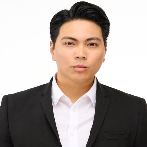 Headshot of a young man in a black suit and white shirt on a white background, ATX Headshots