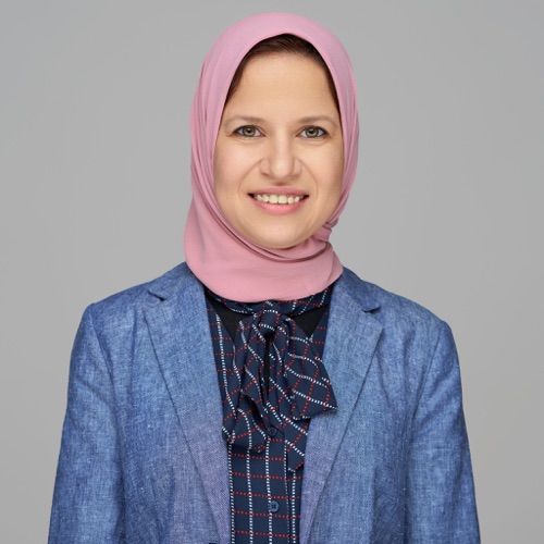 Headshot of a smiling woman in a pink hijab and blue blazer, ATX Headshots