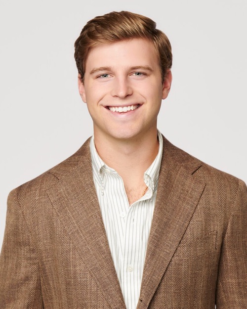 Headshot of a smiling young man in a tan jacket, ATX Headshots