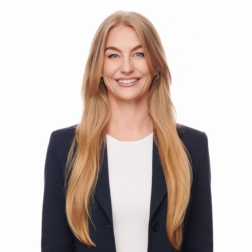 Headshot of a smiling woman with long blonde hair in a navy blazer, ATX Headshots