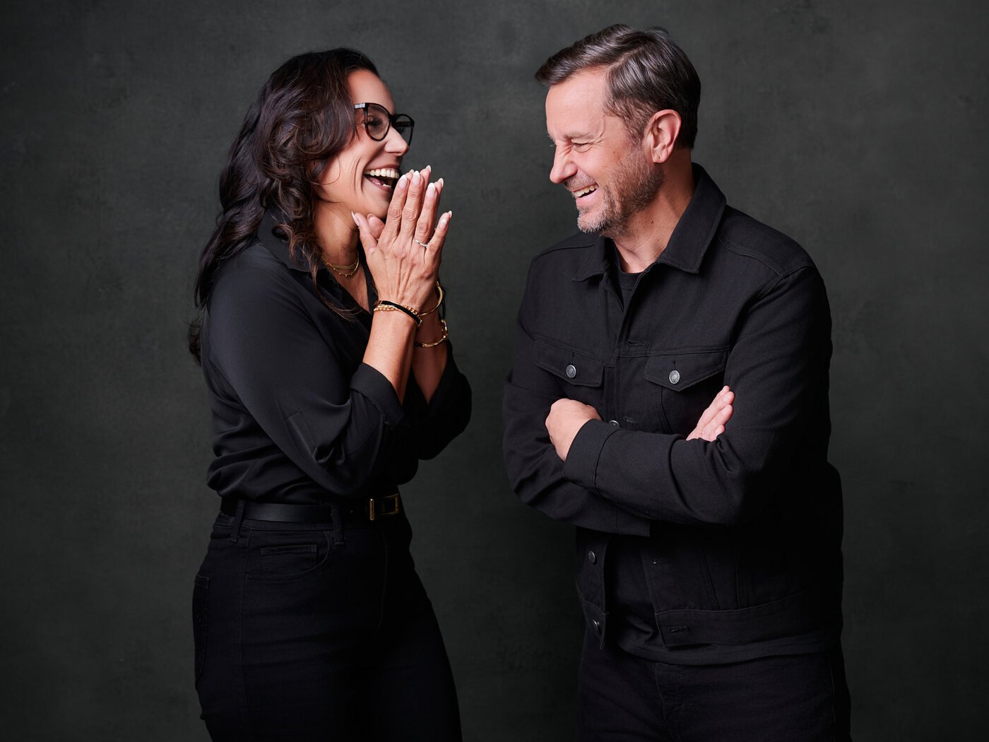 Two clients laughing between frames at a session photographed by Ryan Dunbar